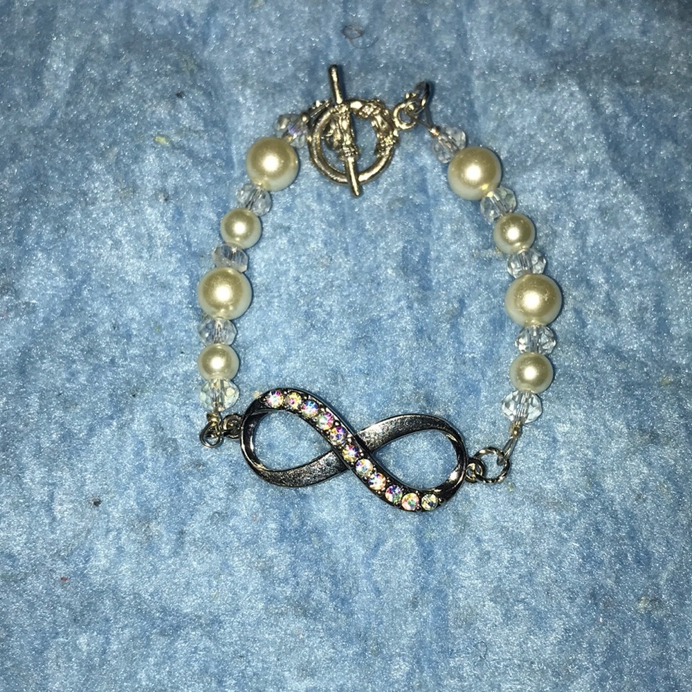 White pearled infinity bracelet.